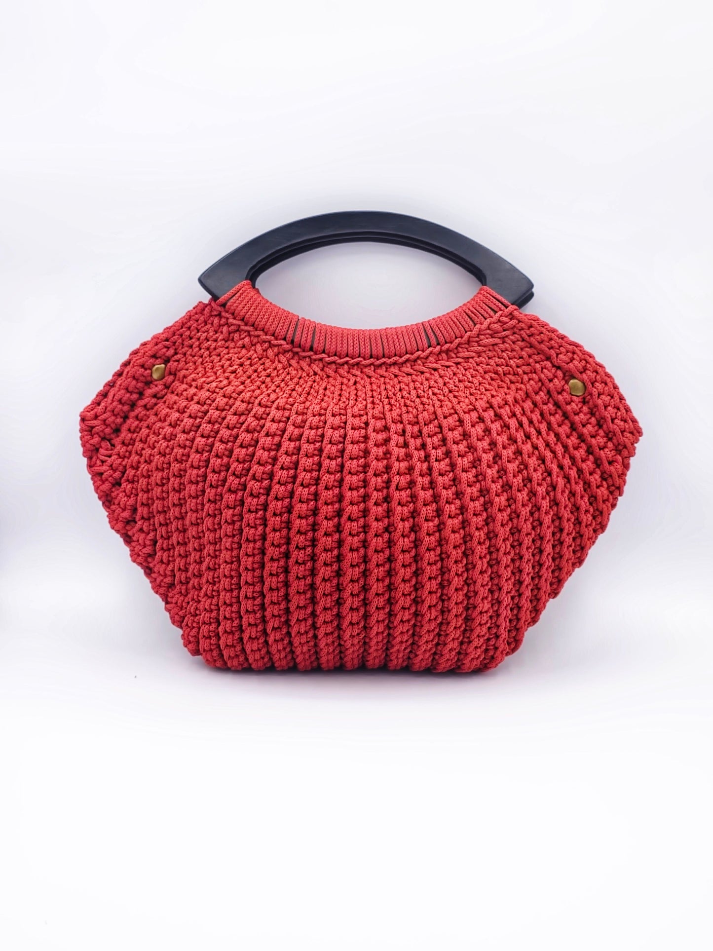 Burnt Orange crochet handbag with a black handle on a white background