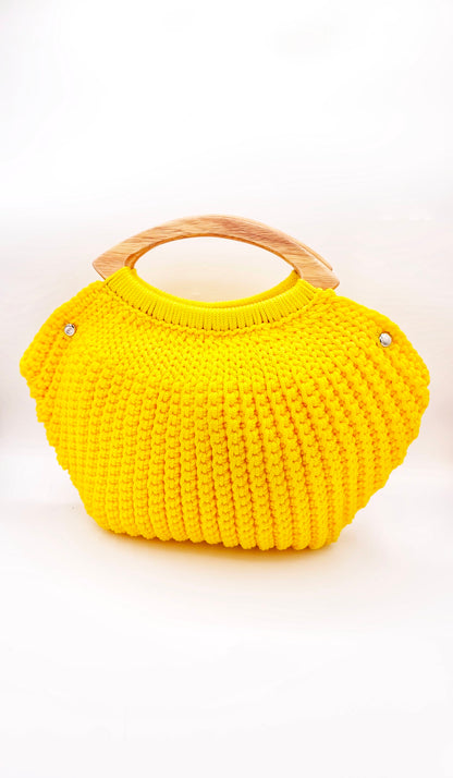 Yellow crochet handbag with wooden handle on a white background